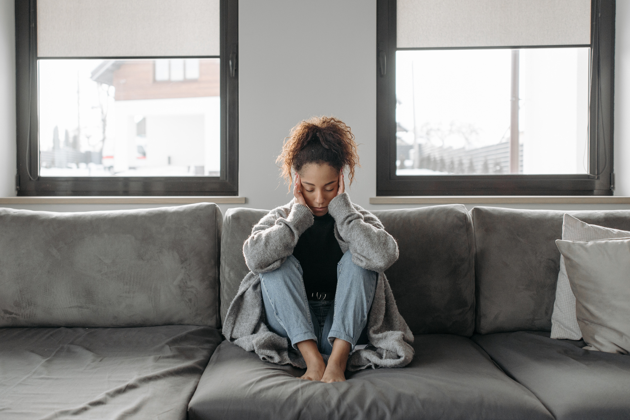 Woman Sitting On A Sofa